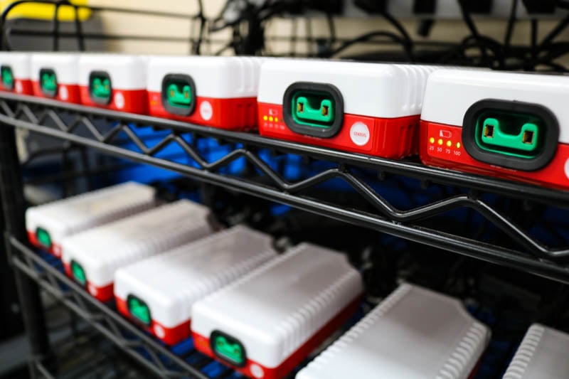 Battery packs are stored on a discharge/charge rack