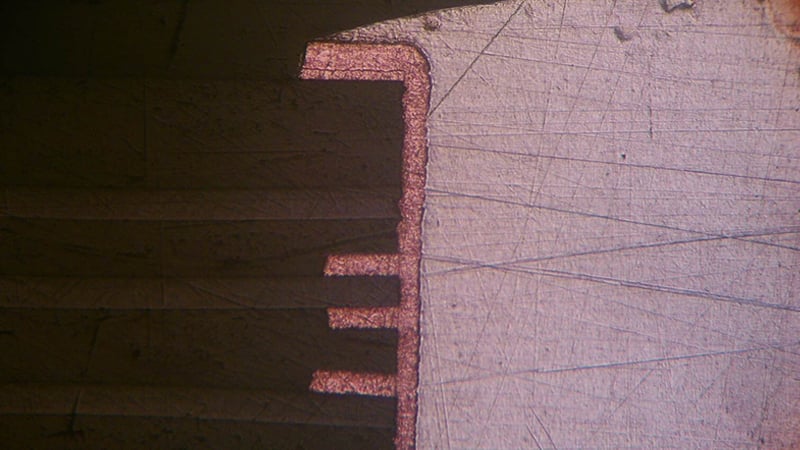 A microscope cross-section of a rigid-flex circuit board and through hole