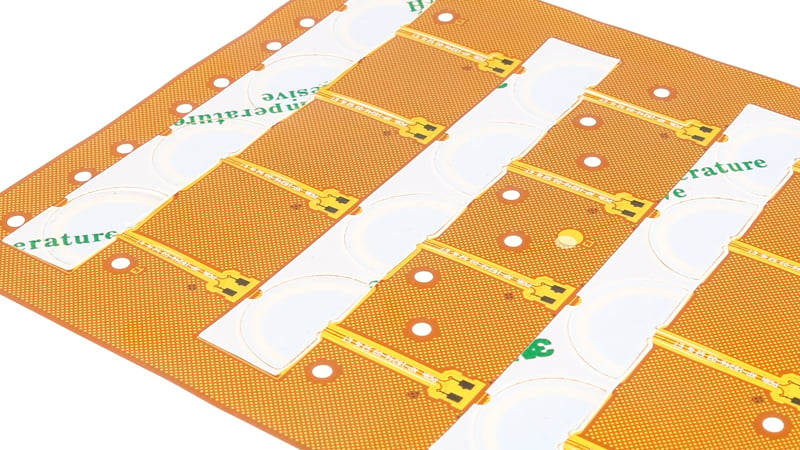 Flexible circuit board with adhesive