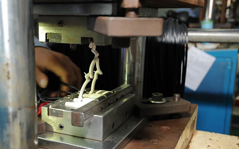 Material flow for overmolded cable assembly