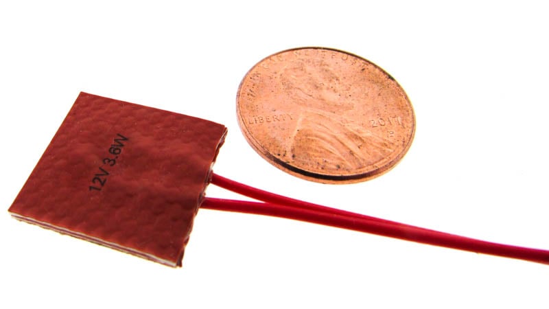 Silicone flexible heater shown next to a penny