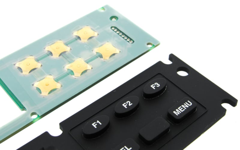 Silicone rubber keypad overlays use adhesives to attach to their base circuits