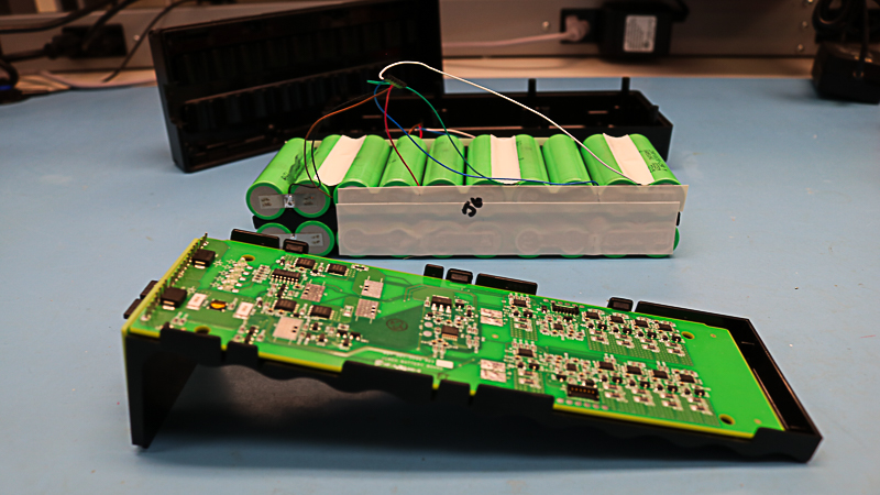Inside of custom battery pack showing electronics, components, and materials.