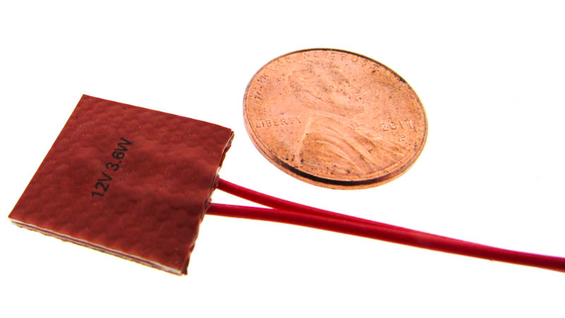 Silicone flexible heater shown next to a penny